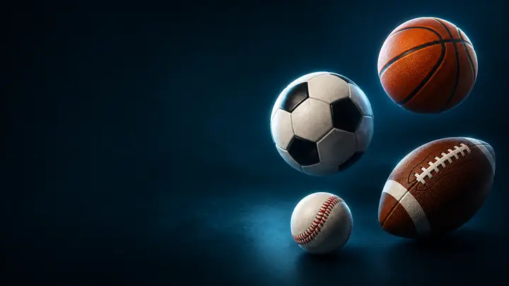 A cluster of sports balls — soccer, basketball, football, and baseball