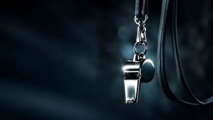 A coach's whistle on a lanyard